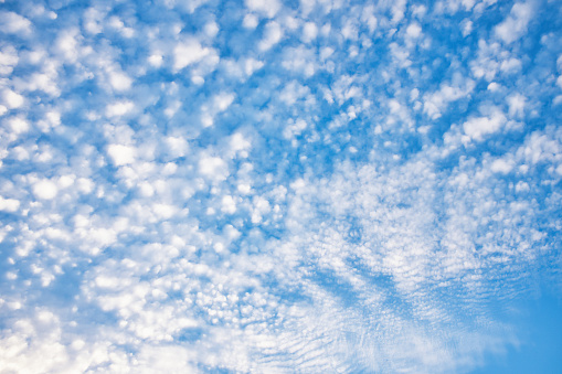 Textured clouds high in the sky make an atmospheric background.