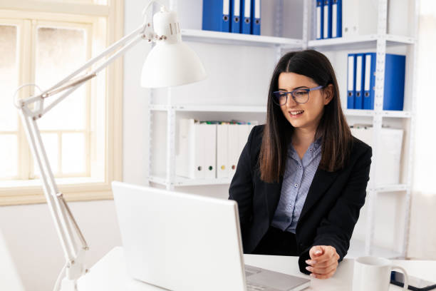 istock The New Normal. New office setup. Woman working alone in the new office space while COVID-19 pandemic. 1295618192