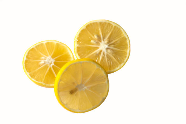 Three slices of lemon on a white background. stock photo