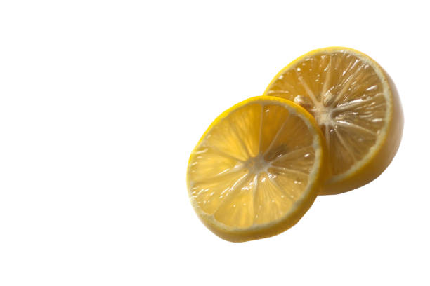 Two slices of lemon on a white background. stock photo