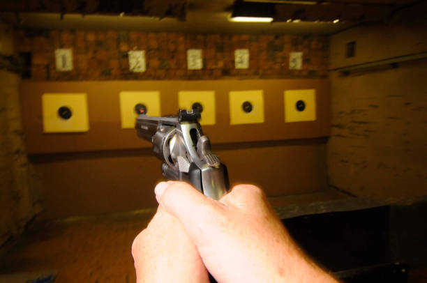 istock sport shooter firing at target 1295621746
