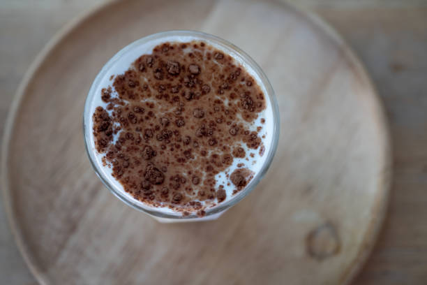 istock Dirty coffee glass (cold milk topped with hot espresso coffee shot) in coffee shop 1295624726