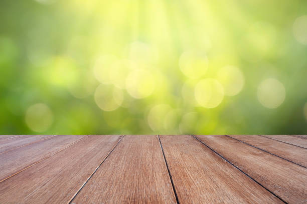 istock natural green background with selective focus. The green background has a bokeh leaf and grass on a white wooden floor. 1295626906