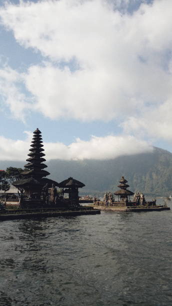 Bedugul lake in Bali island Bedugul is one of place in Bali that has wonderful landscape. In the Lake Bratan we can enjoy the view of the lake and relax with the athmosphere in there. We can round the lake with a boat with our friend or alone. We can also fishing and traveling in there around the lake. floating temple in lake bedugul bali stock pictures, royalty-free photos & images