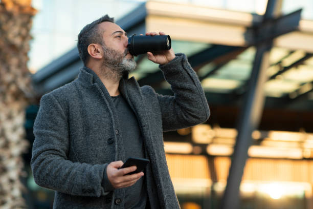 istock A handsome stylish man drinking coffee outside corporate building 1295634405