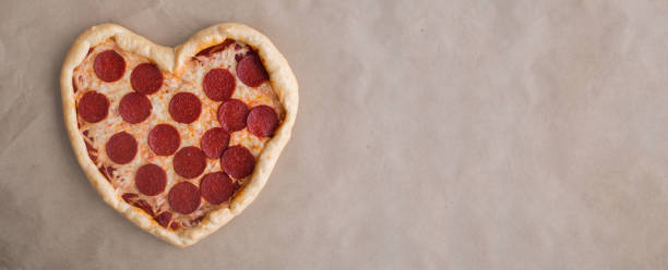 istock Pizza heart shaped with pepperoni 1295635100