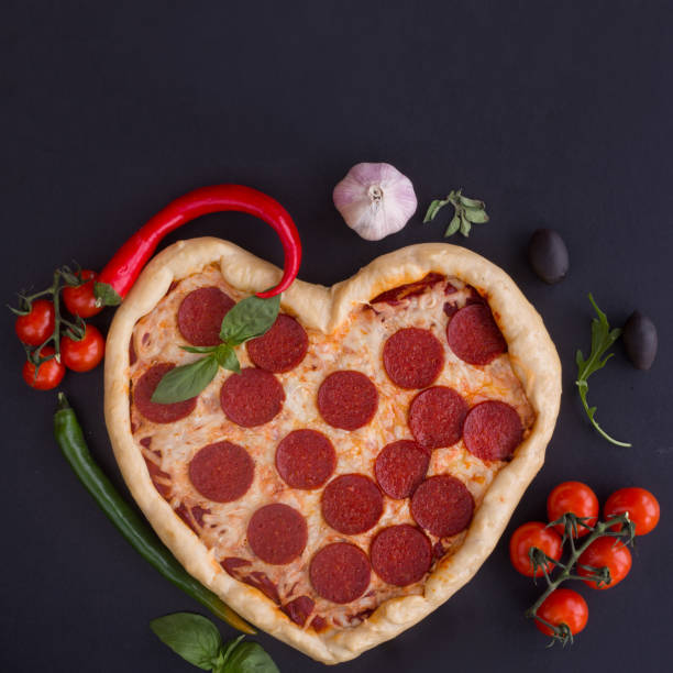istock Pizza heart shaped with pepperoni 1295635128