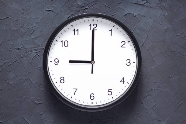 istock Wall clock at wall background surface, minimalism time concept design. Abstract concrete or painted grey texture 1295636179