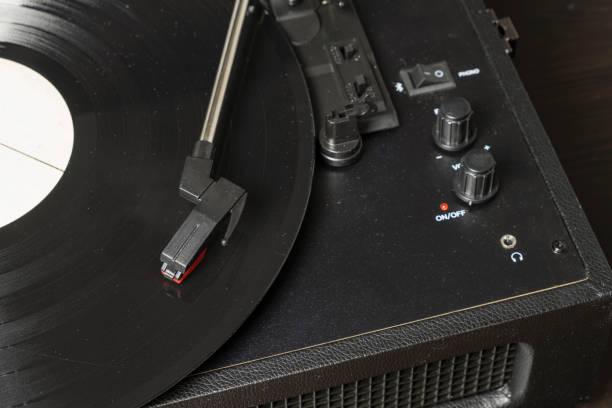 istock Vintage old retro vinyl electronic record player with black record 1295636769