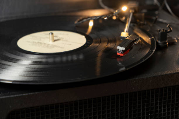 istock Vintage old retro vinyl electronic record player with black record 1295637461