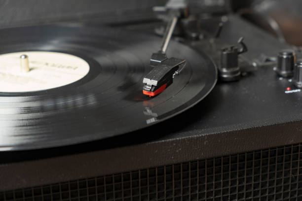 istock Vintage old retro vinyl electronic record player with black record 1295637491