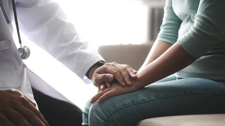 Male Doctor wear uniform Holding hand of patient, Slow motion, older people healthcare support concept, close up view