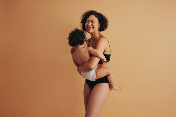istock Cheerful woman with her baby 1295639468