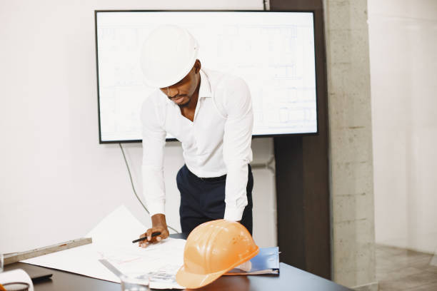 istock Young manager in the office with helmet 1295641369