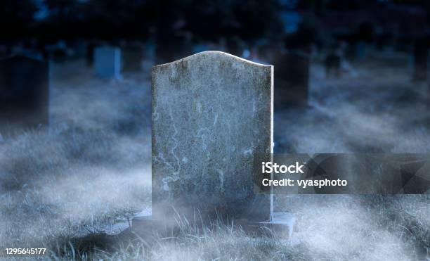 Creepy Blank Gravestone In Graveyard At Night With Low Spooky Fog Stock Photo - Download Image Now