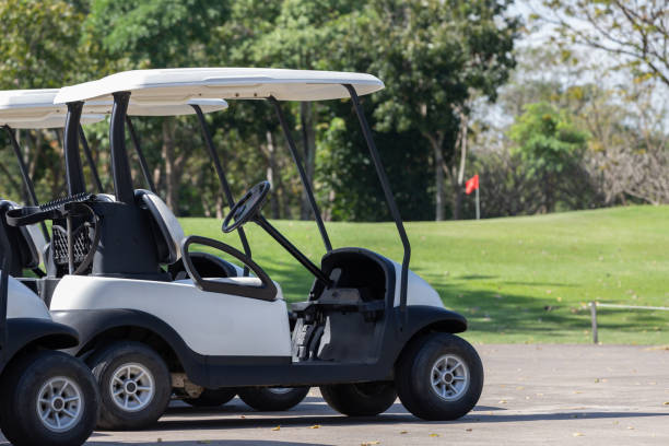 istock electrical golf car on concrete road of golf course. 1295645341