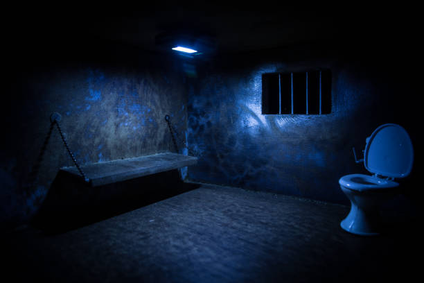 istock Jail or prison cell. Old grunge prison miniature. Dark prison interior creative decoration. Empty cell. Selective focus Obsolete gray grunge concrete room. 1295647683