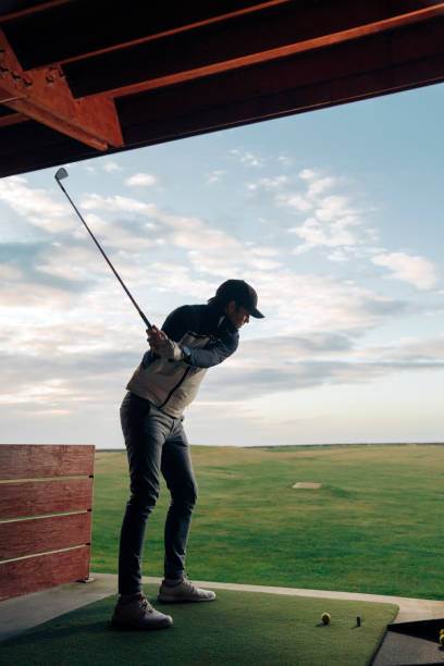 istock Male athlete playing golf at course against sky 1295648111