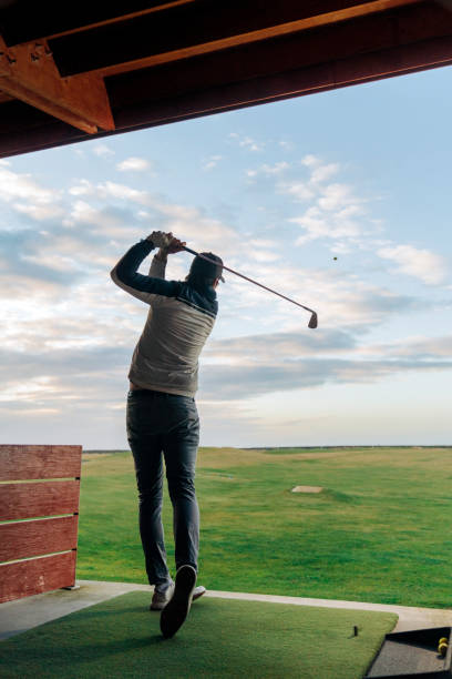 istock Sportsman teeing off at course against sky 1295648736
