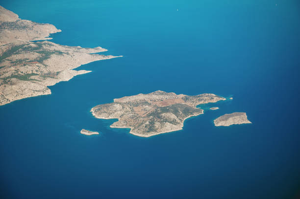 Aerial view over Sesklio island, Greece. Symi, also transliterated as Syme or Simi, is a Greek island and municipality. It is mountainous and includes the harbor town of Symi and its adjacent upper town Ano Symi, as well as several smaller localities, beaches, and areas of significance in history and mythology. Symi is part of the Rhodes regional unit