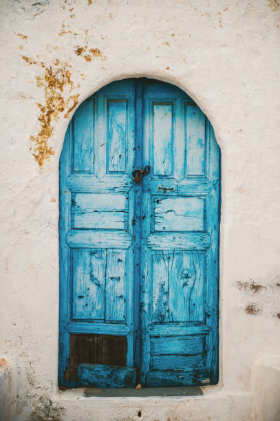 istock Abandoned house with White wall and Blue Doors on Rhodes 1295649318