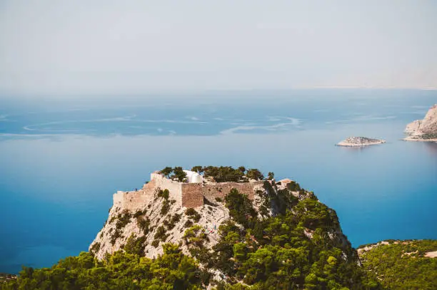 View over Castle of Monolithos, Rhodes. Overlooking the Venetian Castle at Monolithos built in 1480 by the Knights of Saint John, Rhodes Greece Europe