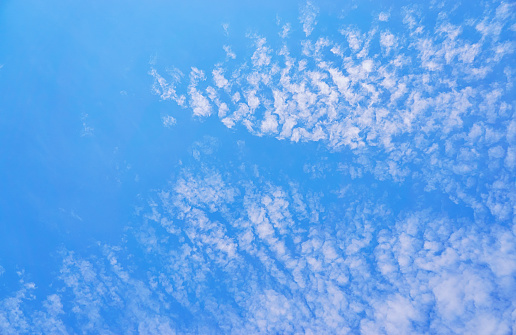 Blue background with spots of white clouds.