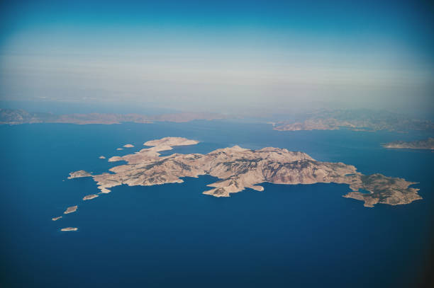 Aerial view over Simi island, Greece. Symi, also transliterated as Syme or Simi, is a Greek island and municipality. It is mountainous and includes the harbor town of Symi and its adjacent upper town Ano Symi, as well as several smaller localities, beaches, and areas of significance in history and mythology. Symi is part of the Rhodes regional unit