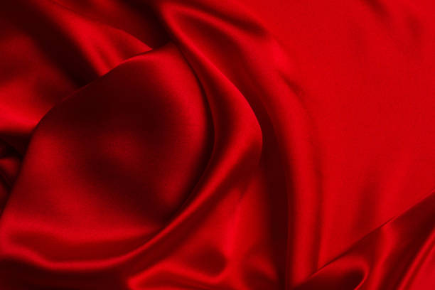 istock Red silk or satin luxury fabric texture can use as abstract background. 1295650441