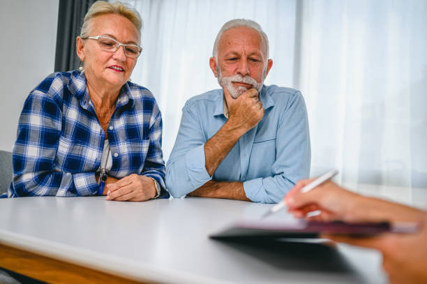 istock Senior couple with financial advisor 1295651478
