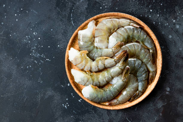 istock Raw shrimps in a plate top view 1295653243