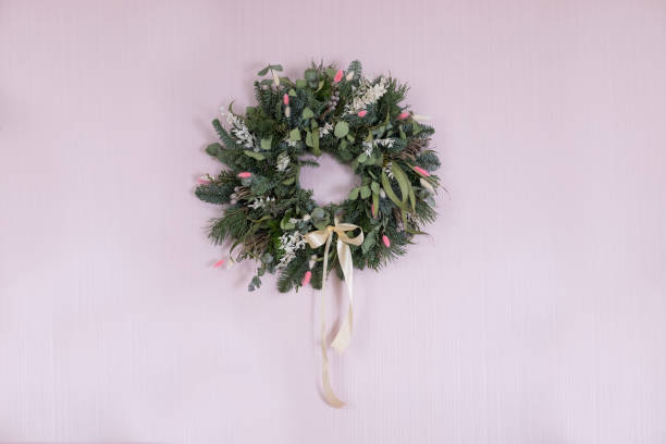 istock spring summer decorative easter wreath with satin ribbon on pink wall 1295653840