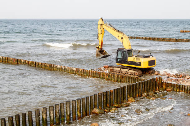 istock excavator during the construction of a breakwater 1295653876
