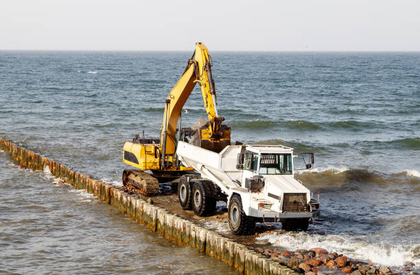 istock excavator loads soil into a large truck 1295653889