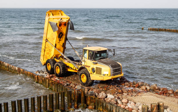 istock heavy truck during the construction of a breakwater 1295653939