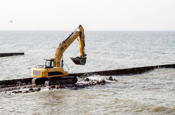 istock excavator during the construction of a breakwater 1295654110
