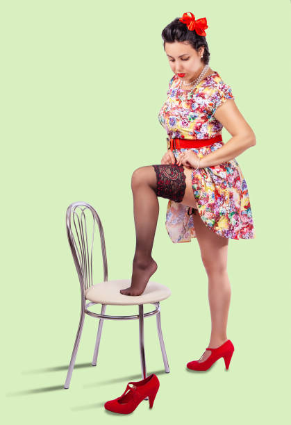 istock young woman straightens her stocking 1295654228