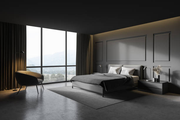 istock Gray master bedroom corner with armchair 1295654433