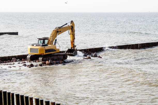 istock excavator during the construction of a breakwater 1295654529