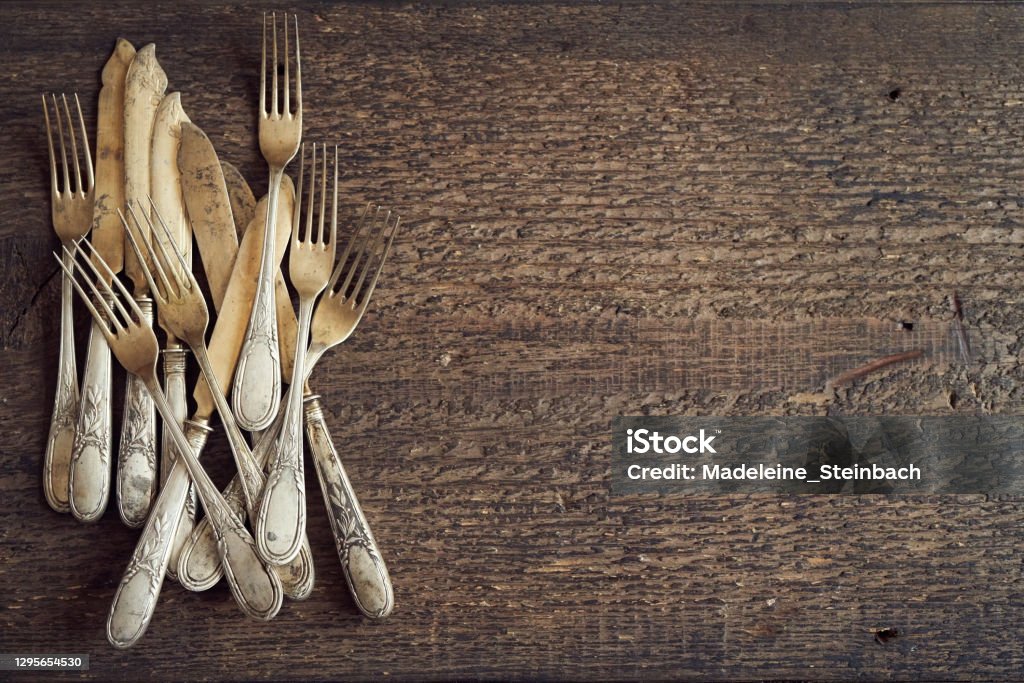 Old rusted vintage silverware on a wooden background, top view Old rusted vintage silverware on a wooden background, top view with copy space Aging Process Stock Photo