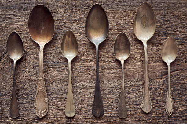 istock Seven empty alpacca vintage spoons on a wooden rustic background 1295654532