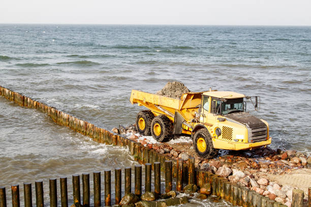 istock heavy truck during the construction of a breakwater 1295655389