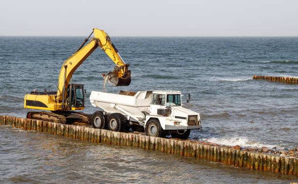 istock excavator loads soil into a large truck 1295655399