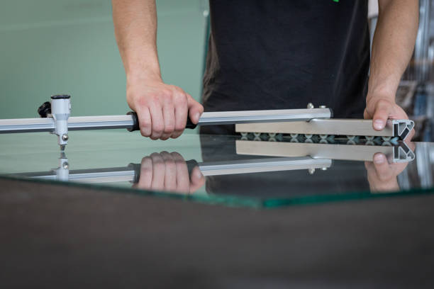 istock A man cuts the glass with the help of specialized tools in a glass workshop 1295656482