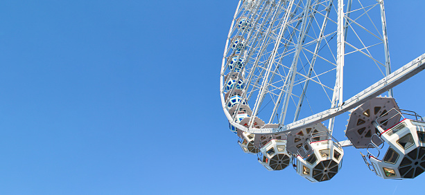Looking up at part of a large Ferris wheel.