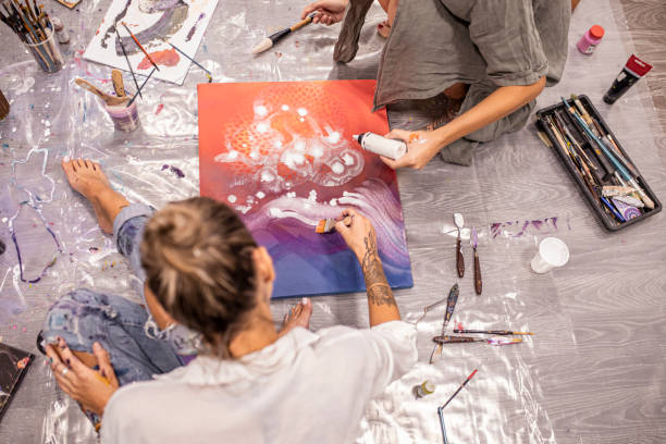 istock Two female artists being busy with creative work at workshop. 1295658264