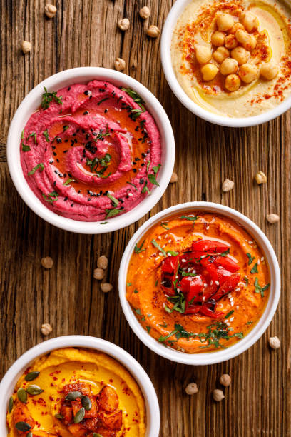 different types of hummus on a wooden background - bruschetta buffet party food imagens e fotografias de stock