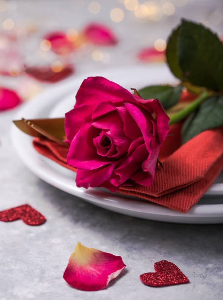 istock Valentines dinner with table place setting  hearts decoration, rose for valentines days dinner. View from above. 1295659513