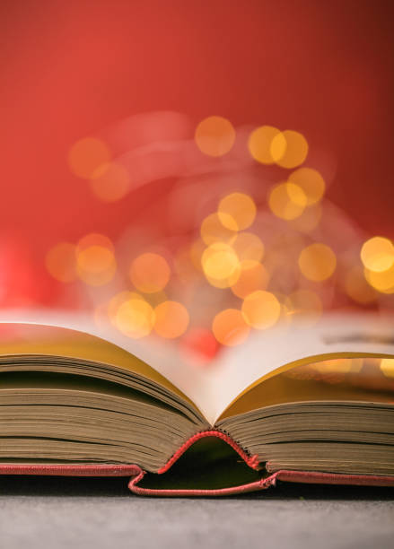 istock Book with lights on red background. Romantic Valentine  concept 1295660432