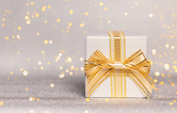 istock Present box on glittering background. Festive and holiday theme. 1295663642